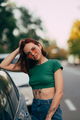 Beautiful fashionable young woman in glasses posing near car - PhotoDune Item for Sale