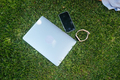 Laptop on green grass in park. Close view - PhotoDune Item for Sale