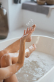 Cropped view of young woman lying in foamy bath - PhotoDune Item for Sale