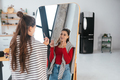 Young woman applies makeup on her face in front of the mirror - PhotoDune Item for Sale