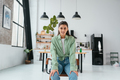 Woman sitting on a chair in a modern kitchen - PhotoDune Item for Sale