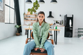 Woman sitting on a chair in a modern kitchen - PhotoDune Item for Sale