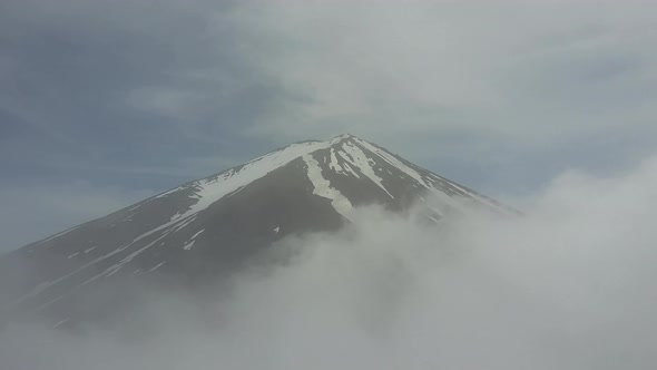 Mount Fuji through the Clouds and obove the Clouds. Clouds opden like a curtain.