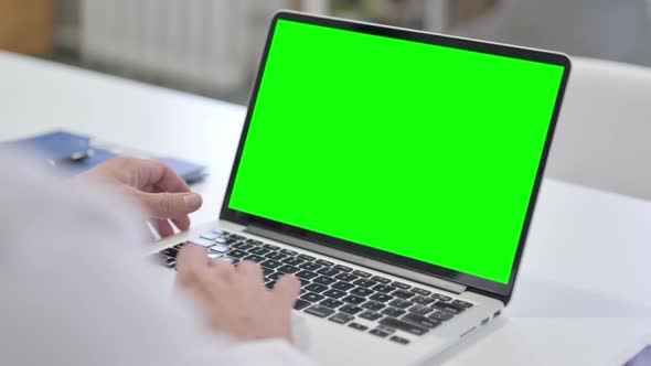 Man using Laptop with Green Chroma Screen