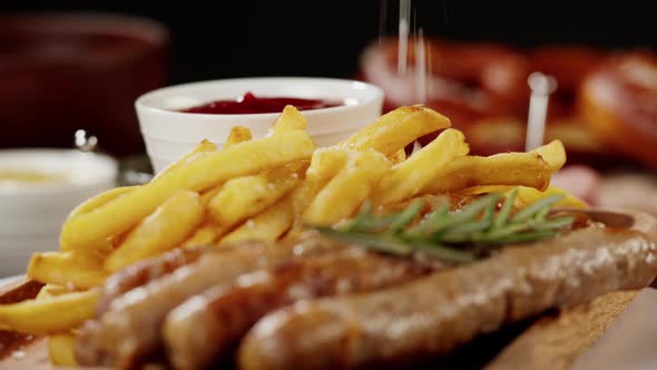 Bowl with Sauce and Smoked Sausages with Fried Potatoes Rotating Closeup