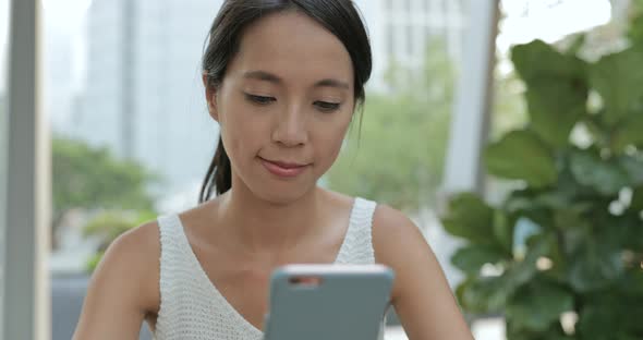 Woman using mobile phone in Hong Kong city