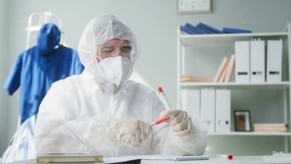 Marking PCR Tests in Laboratory Doctor Writing Results on COVID19 Swab Collection Kit Lab Worker in