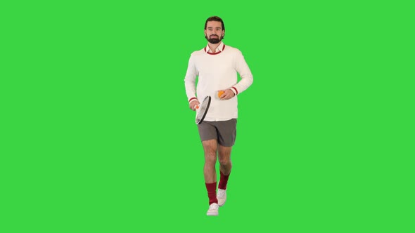 Handsome Tennis Player Running with Tennis Racket on a Green Screen Chroma Key