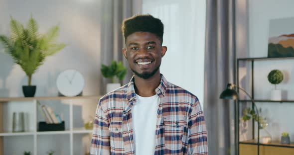 Positive Afro American Man in Casual Clothes Posing Ondoors