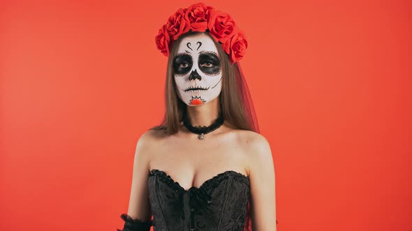 Day of Dead Woman with Skull Makeup Clapping Hands Showing Throatslashing Gesture Smiling Posing on