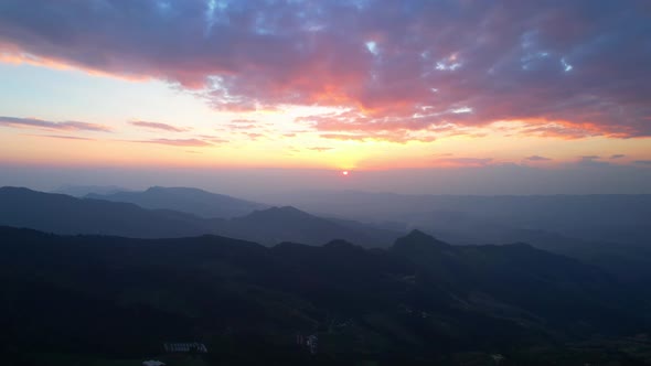 4K Aerial view over mountain scenery at rural Thailand at sunset