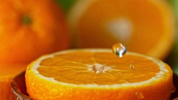 Super Slow Motion Shot of Water Splashing on Fresh Orange at 1000Fps.