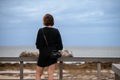 Woman standing and watching the beach - PhotoDune Item for Sale