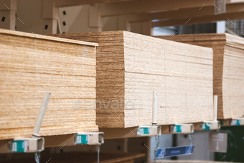 OSB boards in stock, chipboard stacked on pallets in building materials and supplies store