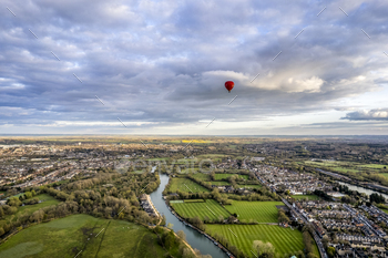 shire, UK with cloudy weather and hot air balloons in the sky