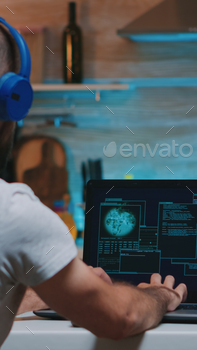 y server annoying the man while working from home. Programmer writing a dangerous malware for cyber attacks using performance device during midnight.
