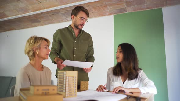 Three architects having discussion in an office