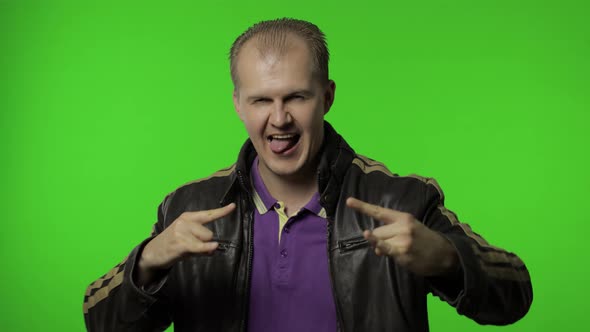 Rocker Man Showing Rock and Roll Sign, Devil Horns Gesture, Looking with Crazy Expression