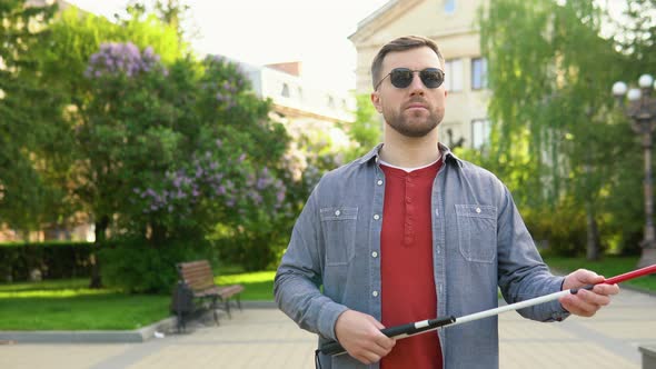 Blind Man Setting Up Walking Cane in Park