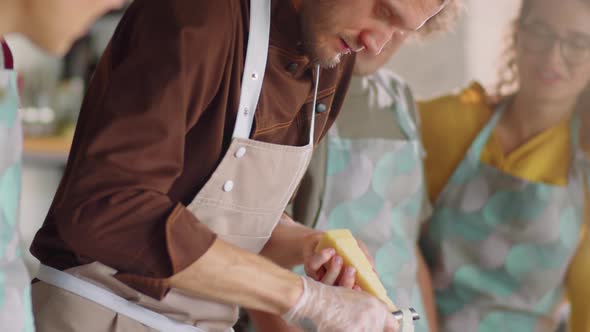 Chef Grating Cheese on Salad during Cooking Class