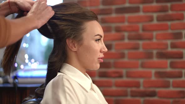 Side View Happy Woman Talking Laughing As Unrecognizable Hairdresser Doing Hairstyle in Beauty Salon