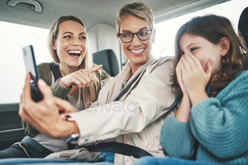  a girl, mother and grandmother in a car for a ho.