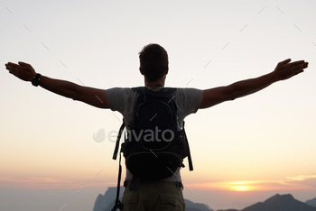 Finding his place in the world. Silhouette shot of a young man standing against the sky.