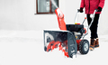 Man using red snowblower machine outdoor. Removing snow near house from yard - PhotoDune Item for Sale