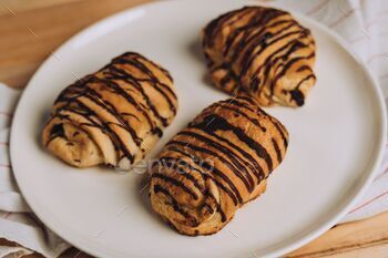 Closeup of Pain au chocolat (chocolatine) pastry with chocolate  on a table