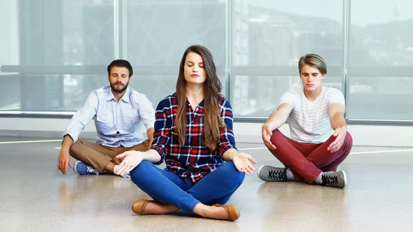 Team of executives practicing yoga