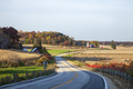 Curving road and farms in Wisconsin on a sunny autumn evening - PhotoDune Item for Sale
