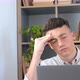 Unhealthy stressed young man suffering headache at home because overwork and studying hard - VideoHive Item for Sale