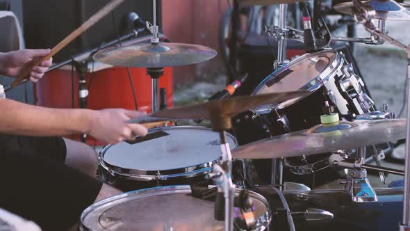 A drummer playing a drum kit. Hit the snare drum, head and cymbals with sticks