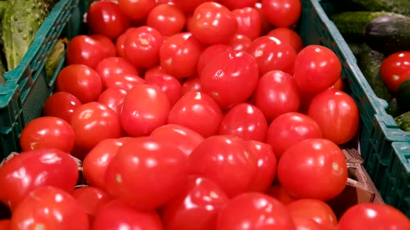 Beautiful red tomatoes in the supermarket are on sale, natural products