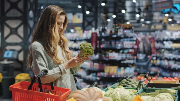 Female Caucasian Woman Female Shopper Consumer Chooses Healthy Tasty Vegetables Holding Green