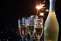 Party composition image. Glasses filled with champagne placed on black table - PhotoDune Item for Sale
