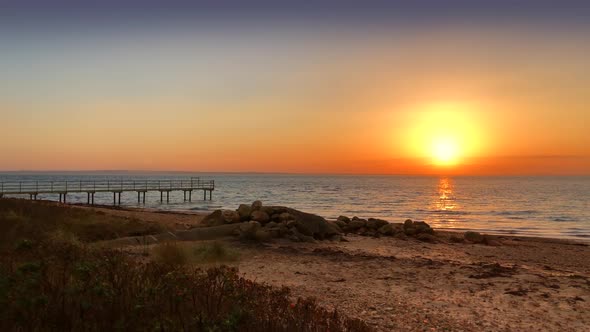 Amazing sunset on a beach near a board walk