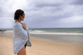Woman seen standing and looking at the waves - PhotoDune Item for Sale