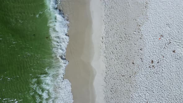 Waves Crashing Peacefully on Sandy Beach - Vertical Aerial Footage