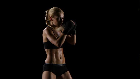 Intensive Training Boxer Girl in a Studio Setting. Slow Motion