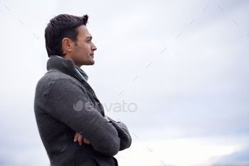 man standing against a cloudy sky