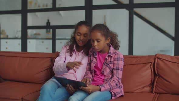 Carefree African Dad Joking on Daughters Indoors