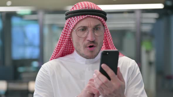 Middle Aged Arab Man Loss on Smartphone