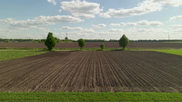 Agriculture Farm Fields Growing in naturePlow Ground Soil For Sowing Aerial Low Angle Flight