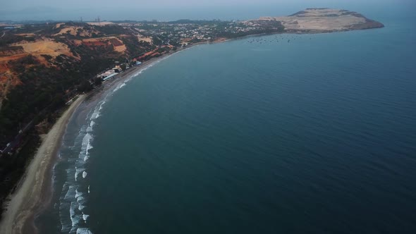 Tropical beach and fishing boats harbour in Hon Rom bay, Vietnam, aerial view