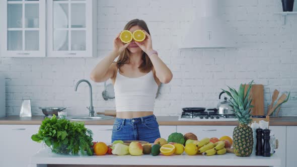 Happy young woman enjoys organic fruit.