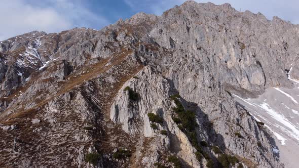 Impressive Rocky Mountain on Sunny Day, Aerial Pullback Tilt Down.