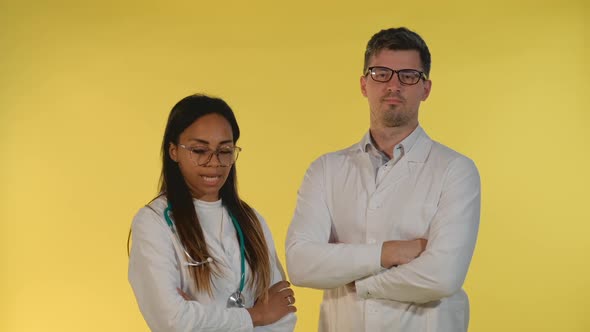 Multiracial Woman and Man in Lab Coat Showing That They are Agree with Something