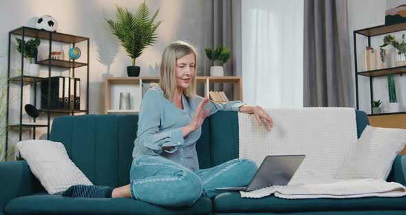 Pretty Aged Lady Using Laptop for Video Conversation