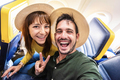 Happy tourist taking selfie inside airplane - Cheerful couple on summer vacation - PhotoDune Item for Sale